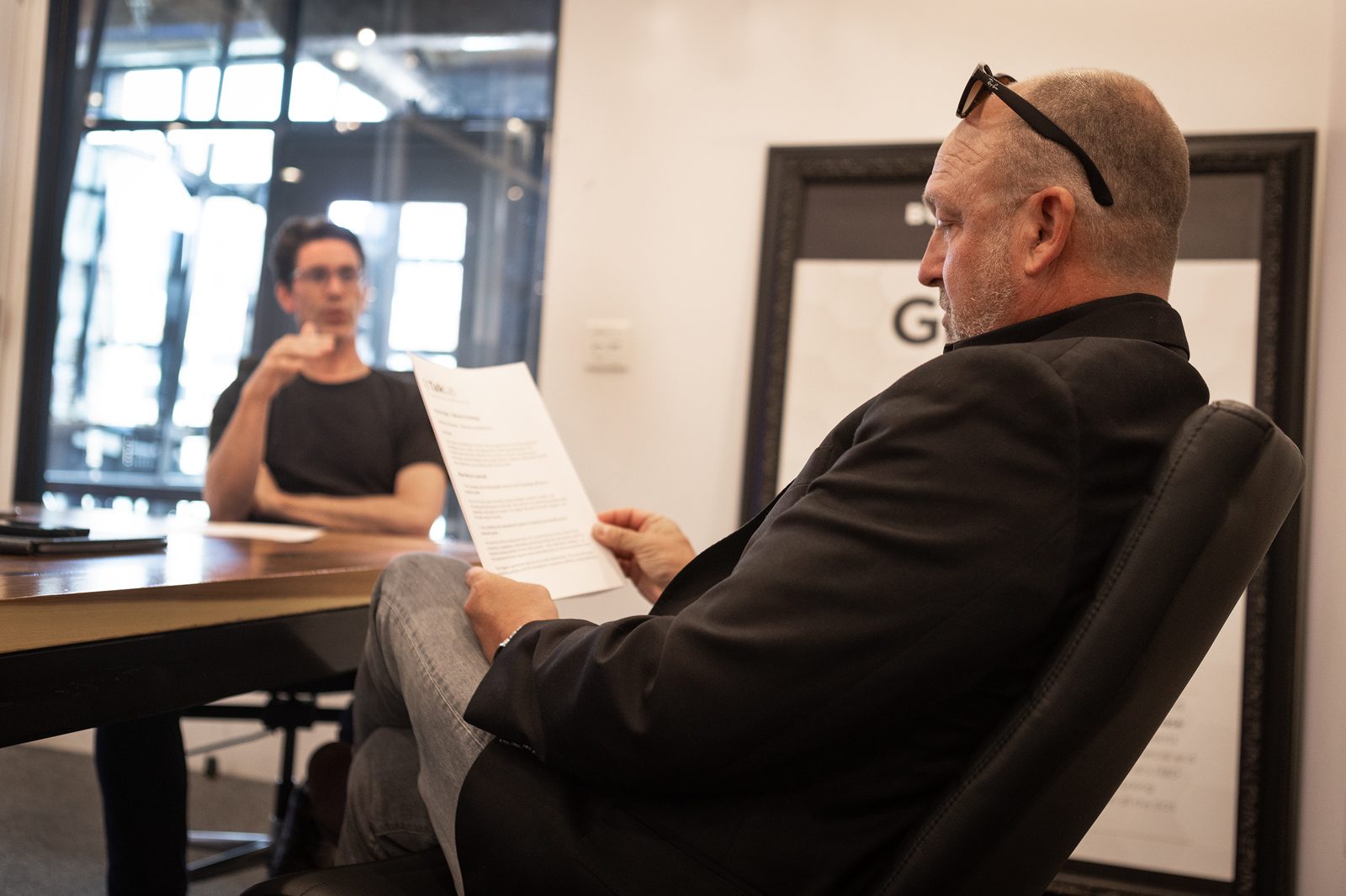 Jimi Allen reviewing notes during a TalkLab conversation in the studio